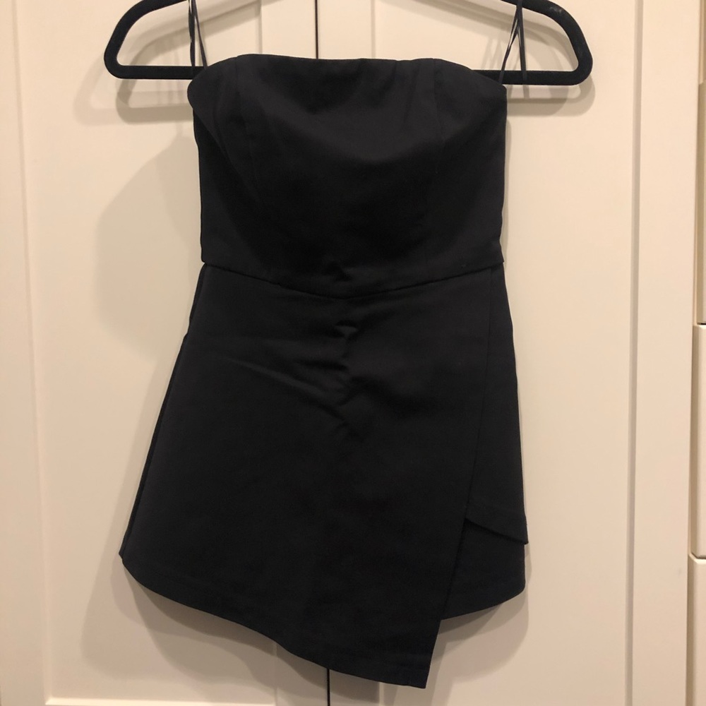 Black strapless romper with envelope skirt front